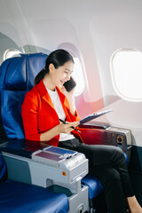 Asian Woman Working on Tablet During  in first class, multitasking with Flight Travel in style, work