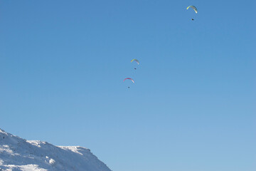 paraglider in the sky in the mountains in winter