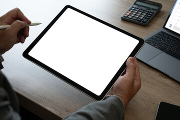hands of a man holding blank tablet a mockup. iPad digital tablet workspace table