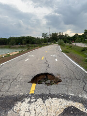 The road used for jogging in the park is damaged.