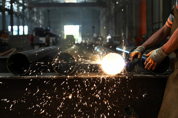 Workers who perform welding and laser cutting on metal