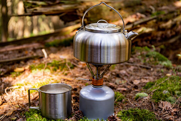 A kettle on the fire during a hike in the mountains.