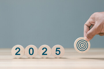 2025 business goals. Wooden block with 2025 word and target icon. set up objective target business...