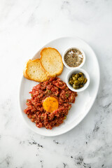Traditional steak tartare with egg yolk