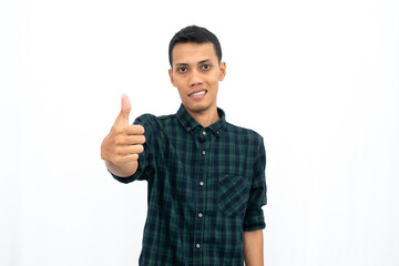 Asian man wearing a green checkered casual shirt stressed showing thumbs up that agree, okay, top....
