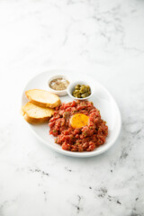 Traditional steak tartare with egg yolk