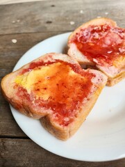 Slice toast bread with strawberry jam and butter