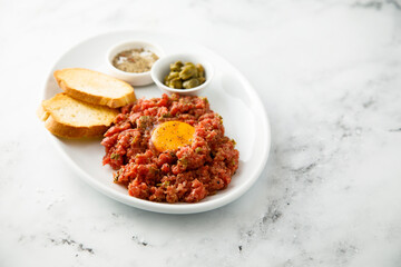 Traditional steak tartare with egg yolk
