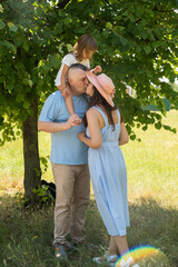 Mom, dad and daughter having fun on a picnic. Family vacation in nature