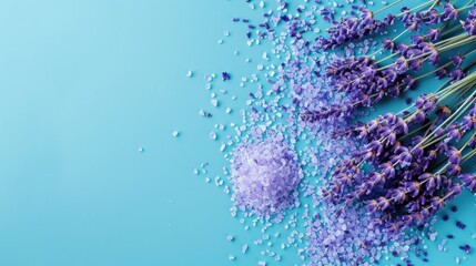 Obraz premium Flat lay of lavender bath salt and dried lavender flowers on a blue background with space for text Organic spa product