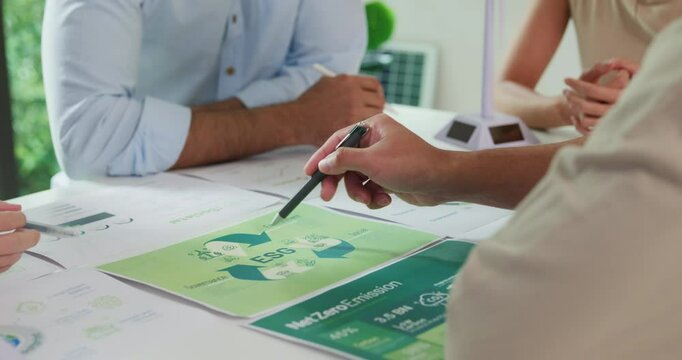 Closeup group Asia businesspeople talk ESG strategies risk management workshop, SDGs report, global warming, green finance investment eco friendly and net zero waste in boardroom training building.