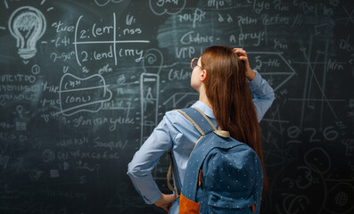 Teenager in class on background of blackboard
