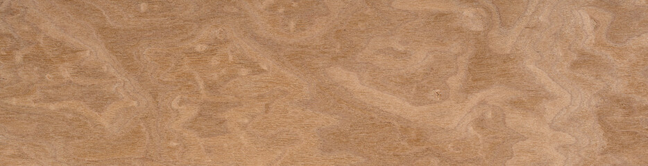 Warm caramel swirls dance across the smooth maple veneer, creating a mesmerizing pattern of organic elegance