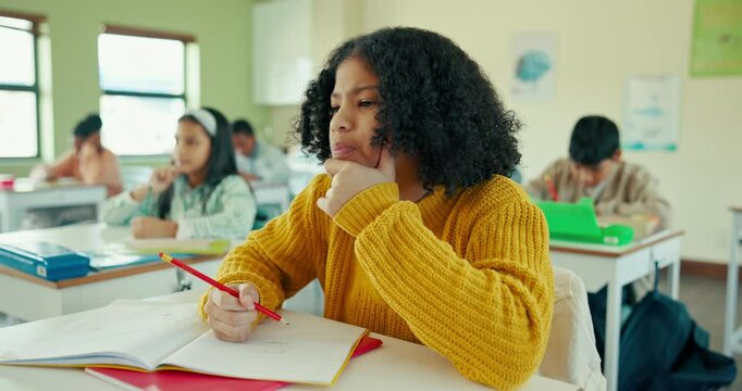 School, thinking and girl child in classroom with writing for learning, knowledge or examination. Academy, student and young kid with notebook for education, problem solving or answer to assessment