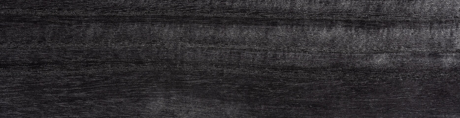 Sleek ebony veneer exudes sophistication with its deep charcoal and onyx tones woven into a smooth texture