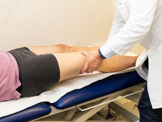 Orthopedic consultation examining patient’s knee