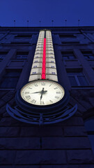 Large street thermometer with clock on the house in Kharkov