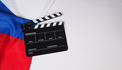 Clapper board and French flag on white background