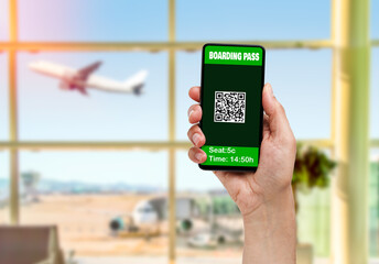 Man showing QR electronic boarding pass to flight on phone at airport