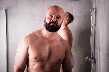 Early morning. An adult gay couple showers together. Love and romantic relationship between two men.