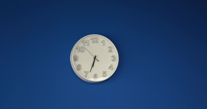white round clock on the dark blue background. End of the working day, office concept . High quality 4k footage