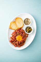 Traditional steak tartare with egg yolk