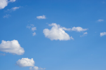 white clouds against a blue sky on a sunny day