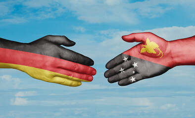 Papua New Guinea and Germany country handshaking with flags, consensus concept international...