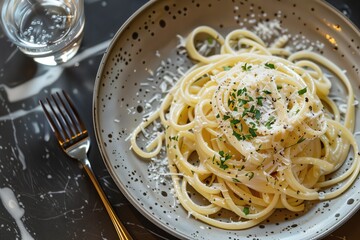 a plate of spaghetti with parmesan cheese on top