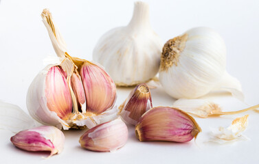 Garlic heads and cloves on white background