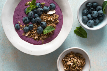 Healthy summer smoothie bowl with blueberries and granola, directly above