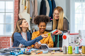 Fototapeta premium Collaboration and creativity in fashion design of teamwork, three diverse and talented designer collaborating on fabric swatches and design choices, creative studio, textile industry, fabric selection