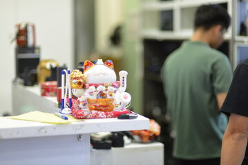 Lucky cat, a symbol of good fortune used to attract customers by small retail shops and family businesses, often worshipped and prayed to, according to Asian tradition and belief