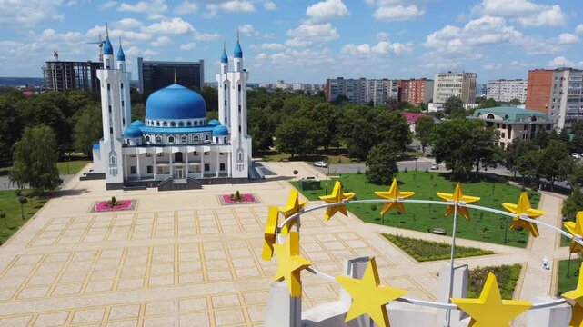 Maykop, Russia. - July 28, 2022: The mosque building in the city center on the central square. Aerial view