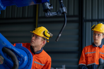 engineers check control heavy machine robot arm. Diverse Team of Industrial Robotics Engineers Gathered Around Machine. Professional Machinery Operators repair electric robot on bright digital panel.