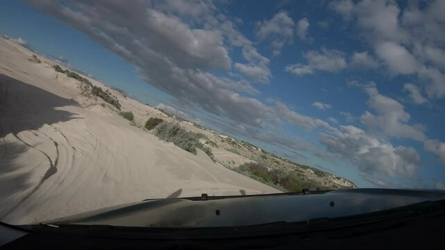 Driving into a sand dune system across an off camber entry, POV shot from windscreen