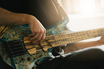 Close-up of Musician Playing Electric Bass Guitar.