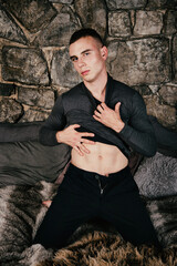 Handsome muscular man resting on his bed at home.