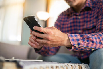 man using cell phone holding mobile texting message contact us.chatting,search internet shopping online.technology device communication connecting