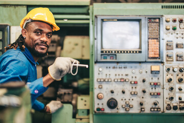 Factory Maintenance Worker uses Flashlight to Inspect and Perform Maintenance on Industrial Machine