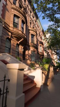 Brownstones with stoop steps in Central Park West Historic District. Row of Townhouses on Upper West Side, Manhattan, New York City