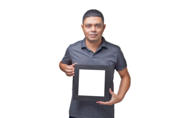Man looking at the camera and holding a square photo frame. Frame concept. Memory concept. Mockup.