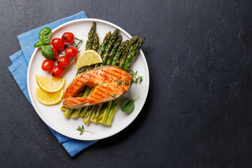 Grilled salmon steak over grilled asparagus, a delicious and healthy meal