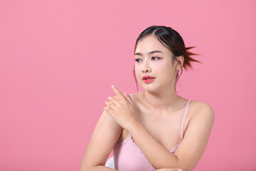 Beautiful young asian woman with clean fresh skin on pink background, Face and skin care