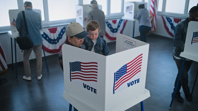 Caucasian man with son enters the voting booth to fill out ballot paper. Diverse US people and American voters vote at polling station. Presidential elections in the United States. Democracy concept.