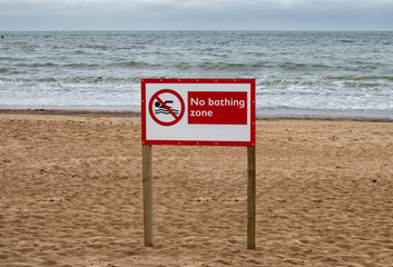No bathing zone sign on Exmouth beach, Devon, United Kingdom