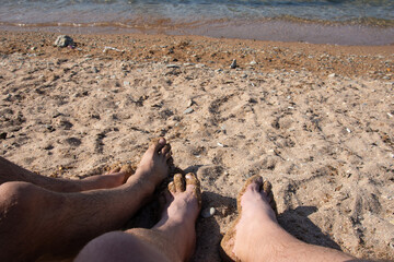 A gay couple relaxes at the seaside in the summer. Love and romantic relationships.