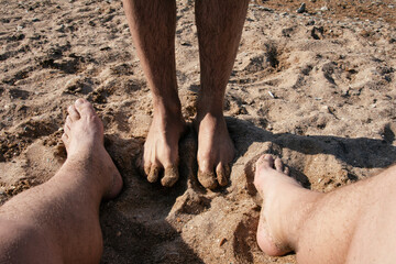 A gay couple relaxes at the seaside in the summer. Love and romantic relationships.