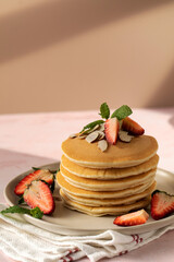 Delicious Fluffy Pancakes with Fresh Strawberries and Almonds and a Touch of Sweetness