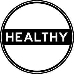 Black color round seal sticker in word healthy on white background